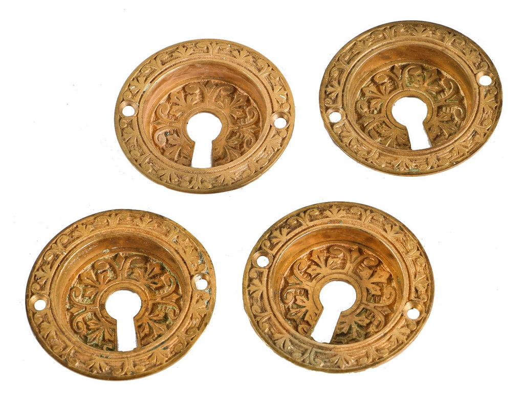 lot of four matching original 19th century ornamental cast bronze circular-shaped interior residential "cup" style pocket door handles with keyholes