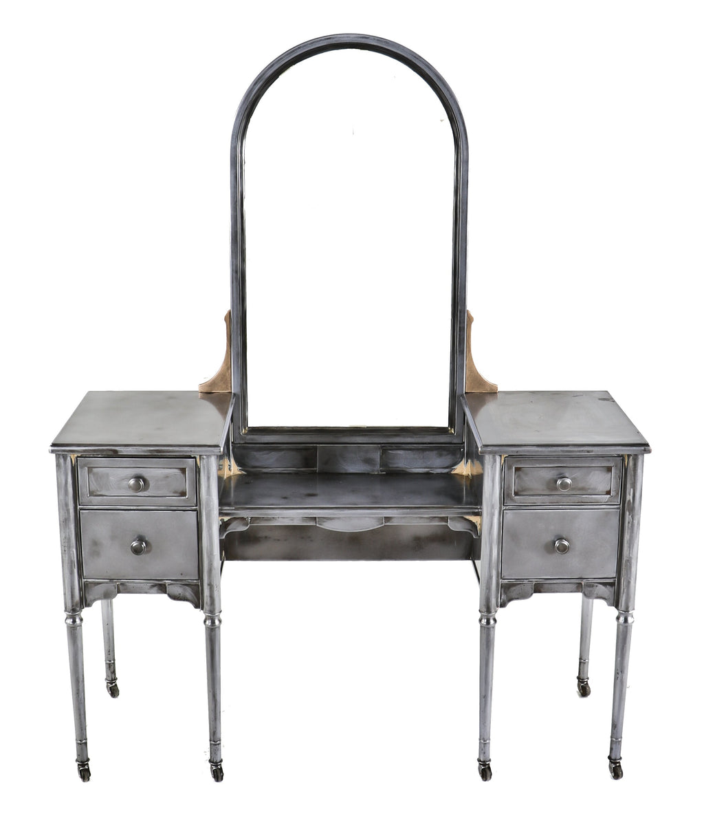 one of several matching original american depression era refinished pressed and folded steel simmons vanities with oversized arch top mirror