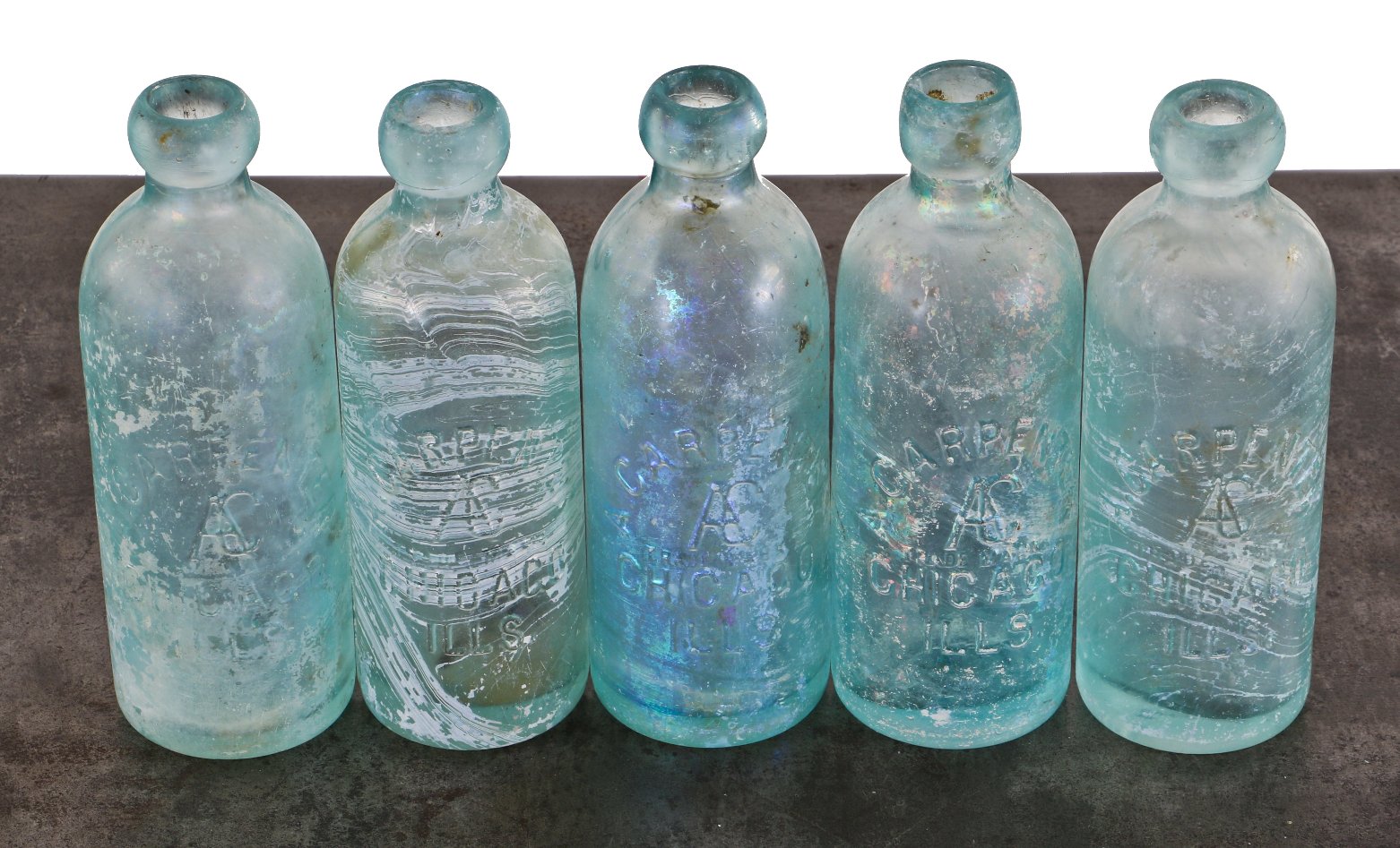 five nearly identical and freshly dug chicago privy andrew carpenter "blob top" light aqua blue bottles with monogrammed bases