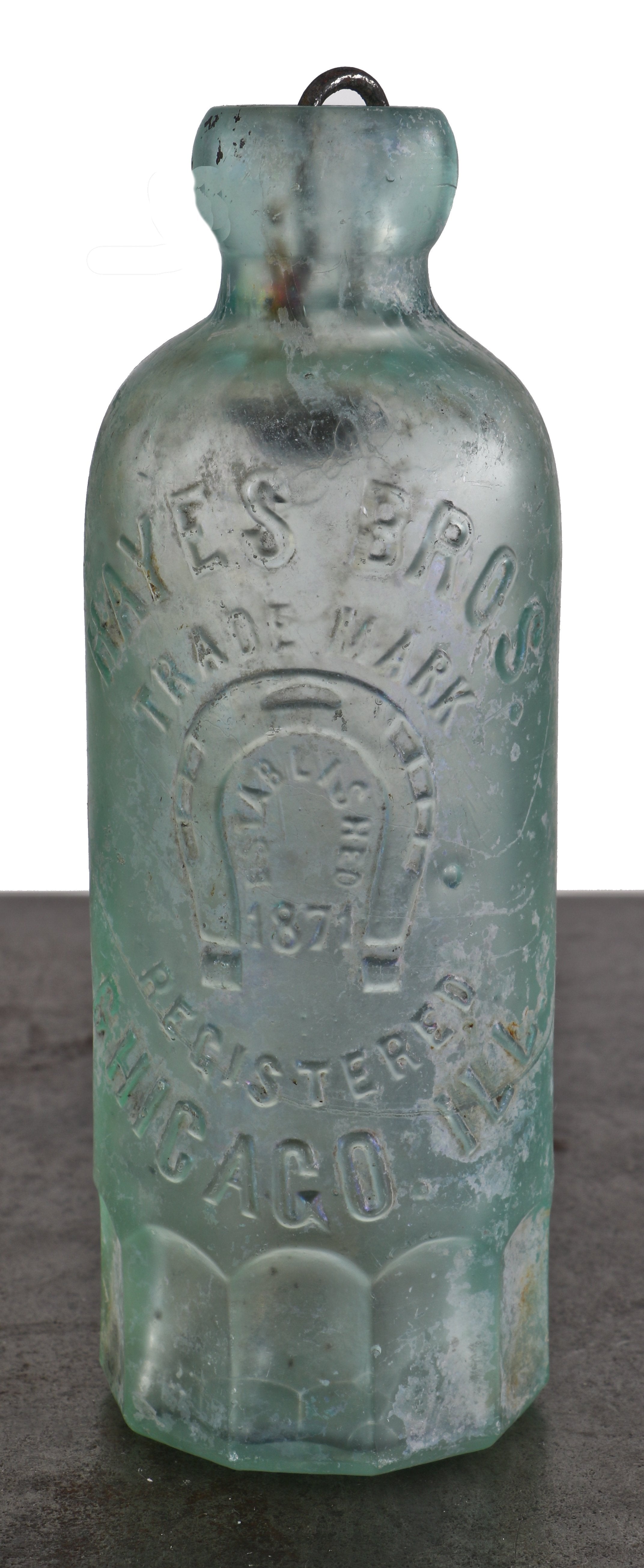 original and intact light blue aqua glass hutchinson shaped bottle with mug base manufactured for michael and patrick hayes in chicago, il.