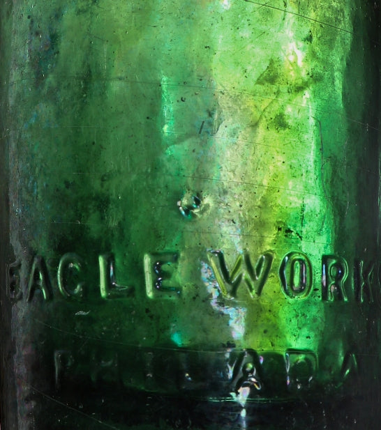 remarkable privy-dug mid-nineteenth century (1847-1849) dark emerald porter style bottle with applied single ring tapered lip and embossed with manufacturer's name