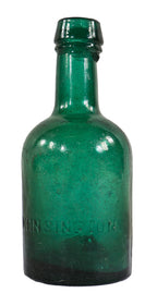 original and intact early nineteenth century deep emerald green porter shaped beer bottle manufactured by kensington glassworks.