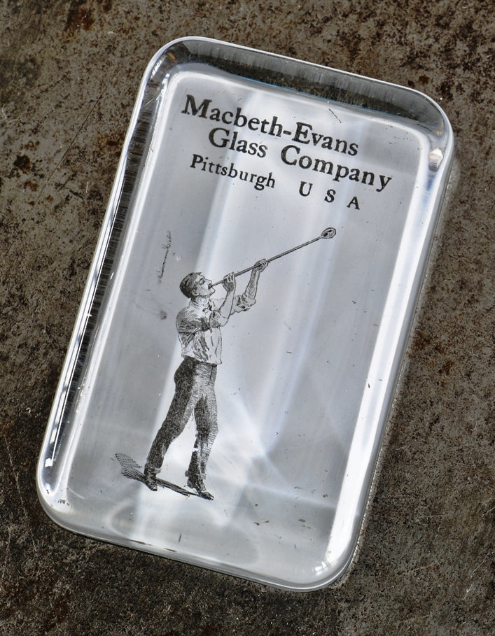 original and well-maintained early 20th century antique american advertising salesman sample glass paperweight featuring a glassblower with blowpipe
