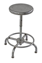 one of two matching original four-legged stationary pressed and folded steel fully adjustable laboratory bench stools with welded joint heel ring or footrest