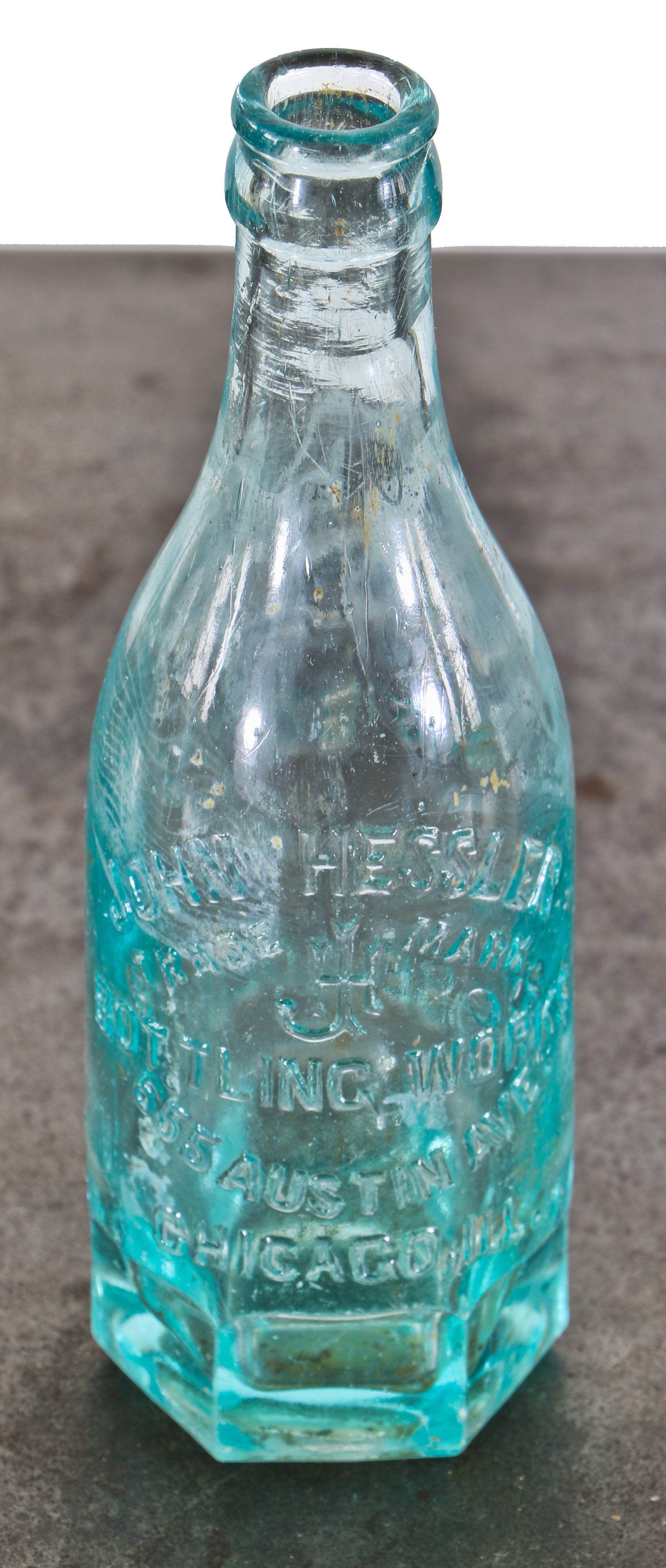 rare unusually shaped turn of the century blue aqua soda or mineral water bottle with mug base manufactured for john hessler.