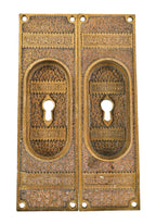 two matching oversized 19th century antique american ornamental cast bronze "ivy" pattern pocket door escutcheons with recessed "cup" handles and keyholes