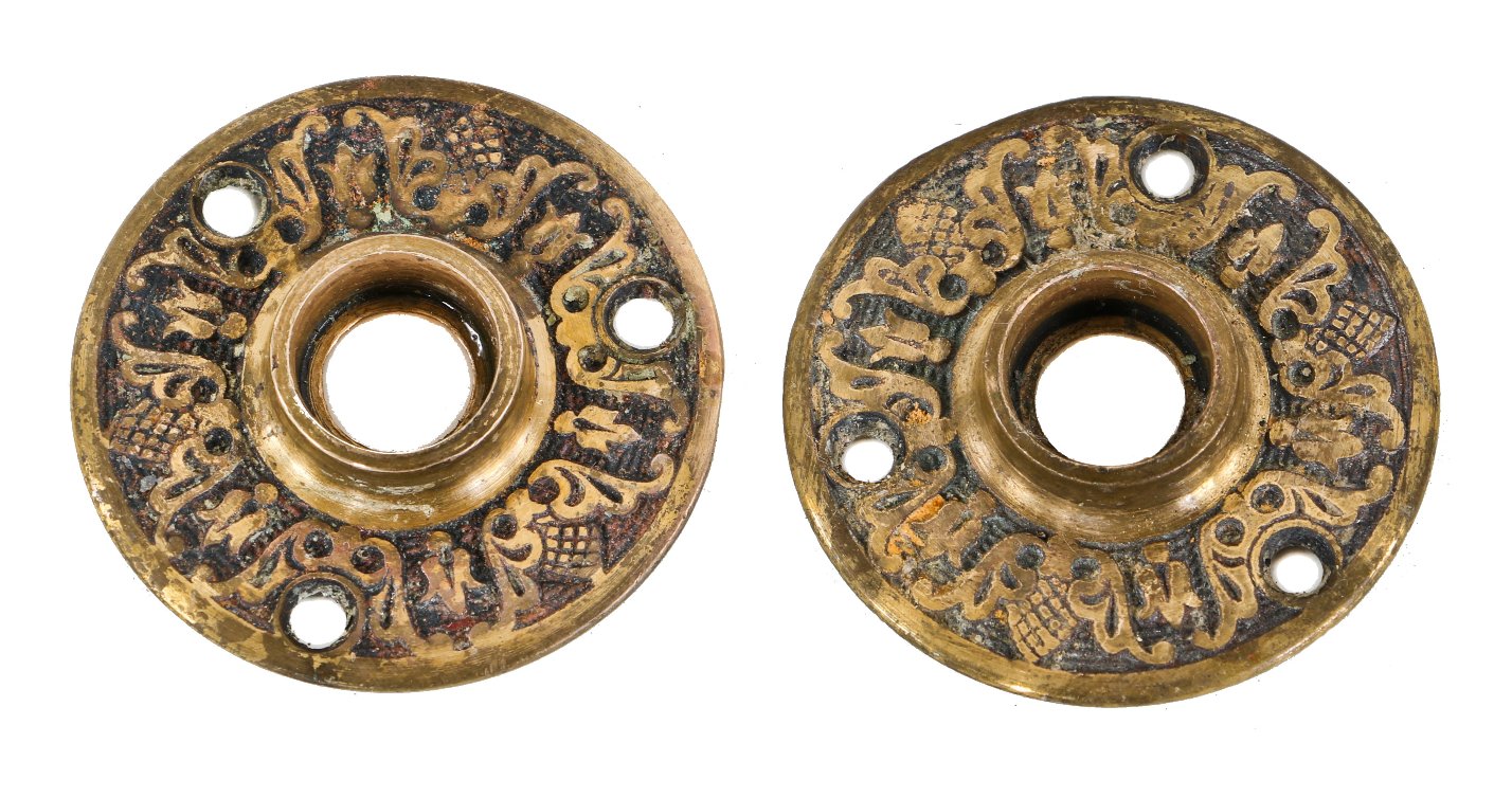 two matching original antique american victorian era ornamental cast brass residential passage door rosettes with partially intact black enameled inlay