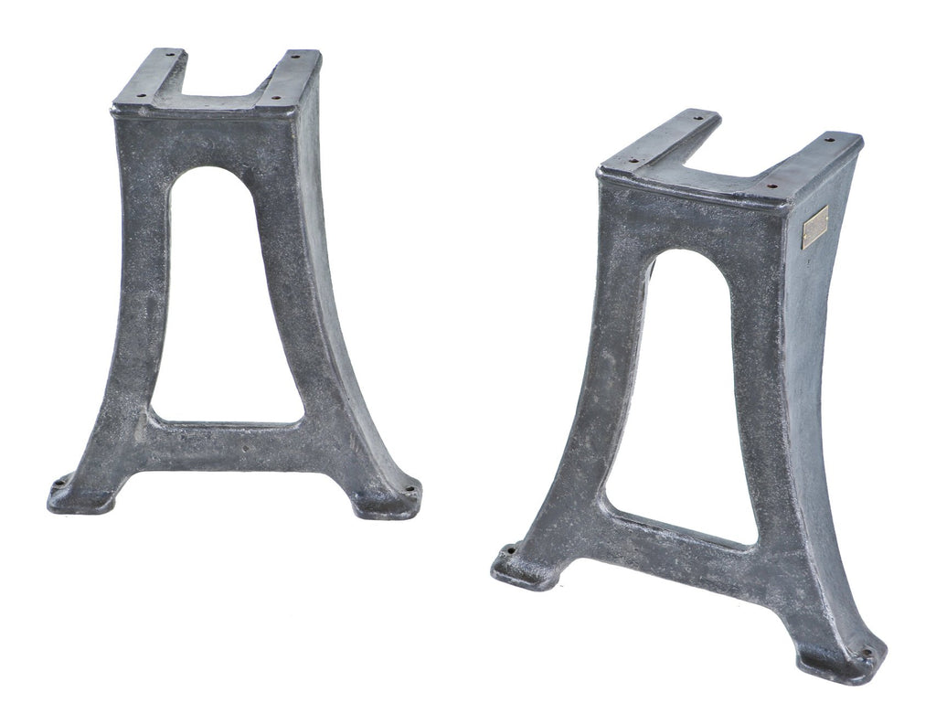 two original early 20th century antique american industrial matching heavy duty cast iron factory lathe machine bases with a brushed and lacquered finish throughout