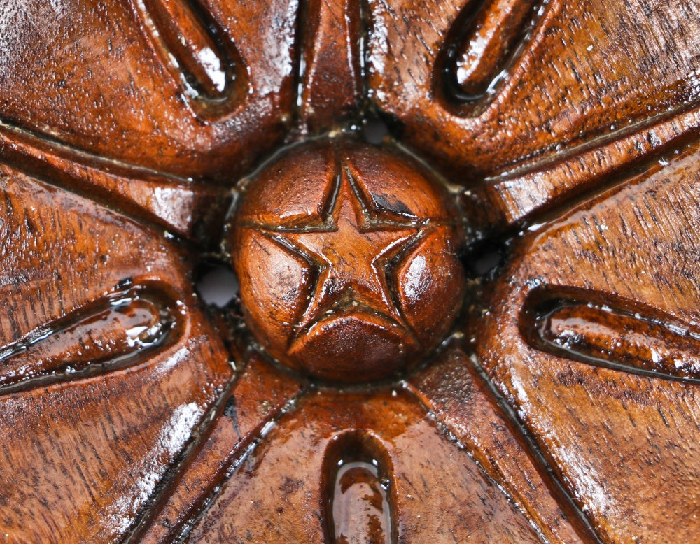 visually striking original and completely intact early 1870's hand carved walnut wood peddled flower with a deeply recessed and centrally located button with incised star