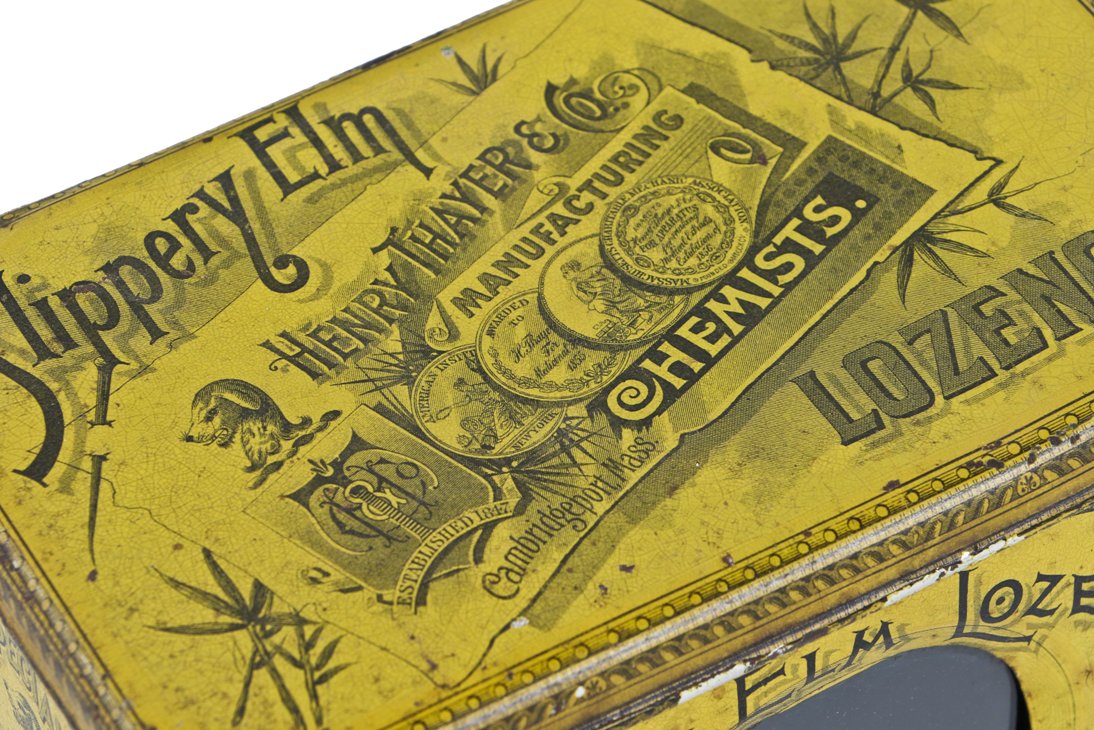 all original exceptionally well-designed and nearly pristine bright yellow lithographed tin "slippery elm" lozenges apothecary or drugstore storage container