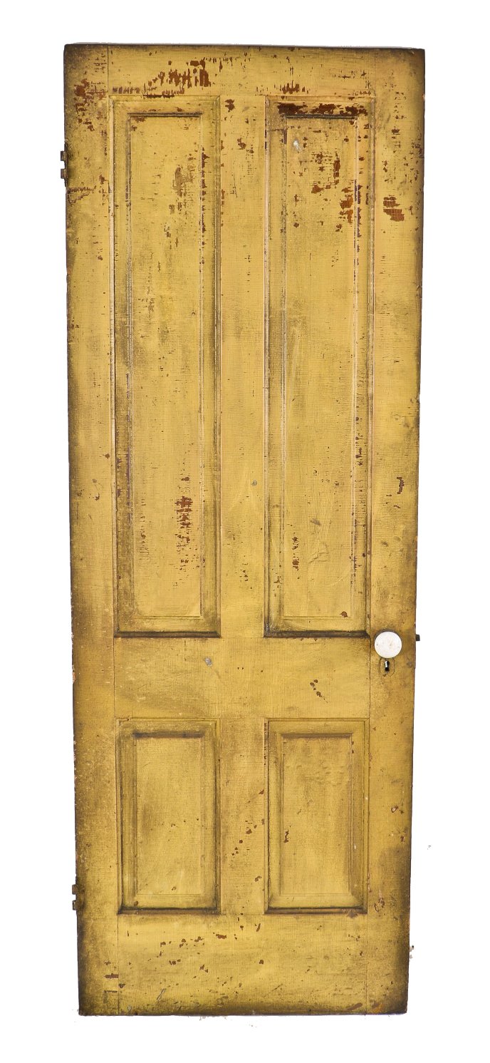 nicely worn and weathered old yellow painted pine wood pre-fire chicago four-panel door with original russell & erwin patented mortise lock and white porcelain doorknobs