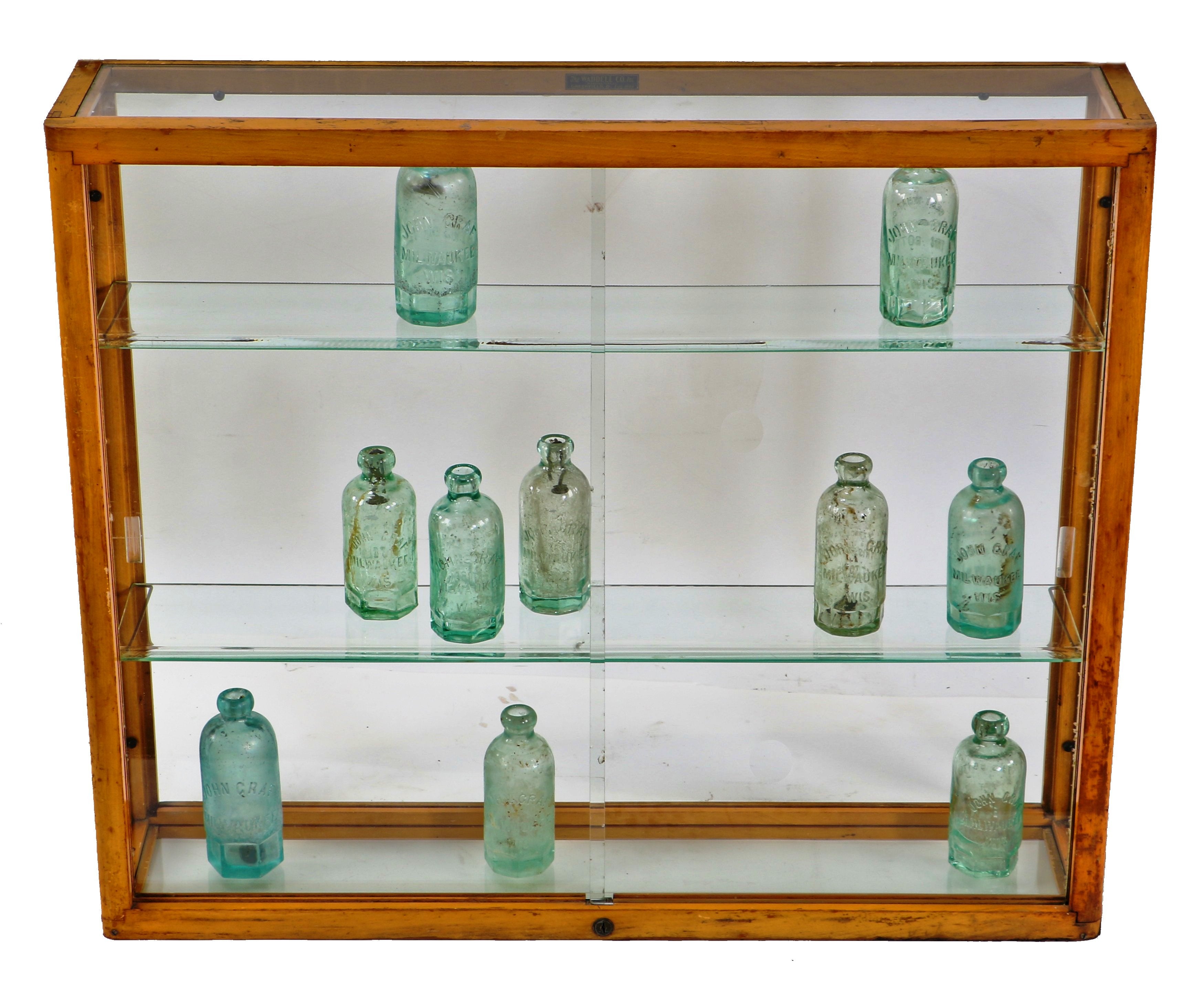 original and intact wall-mount early 1930's american depression-era waddell varnished maple wood compact display case with plate glass sliding doors and adjustable shelves
