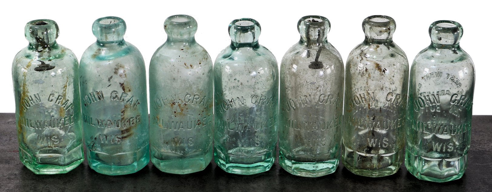 large lot of nearly identical late 19th or early 20th century privy dug milwaukee john graf "mug base" hutchinson embossed soda bottles with applied blobtops