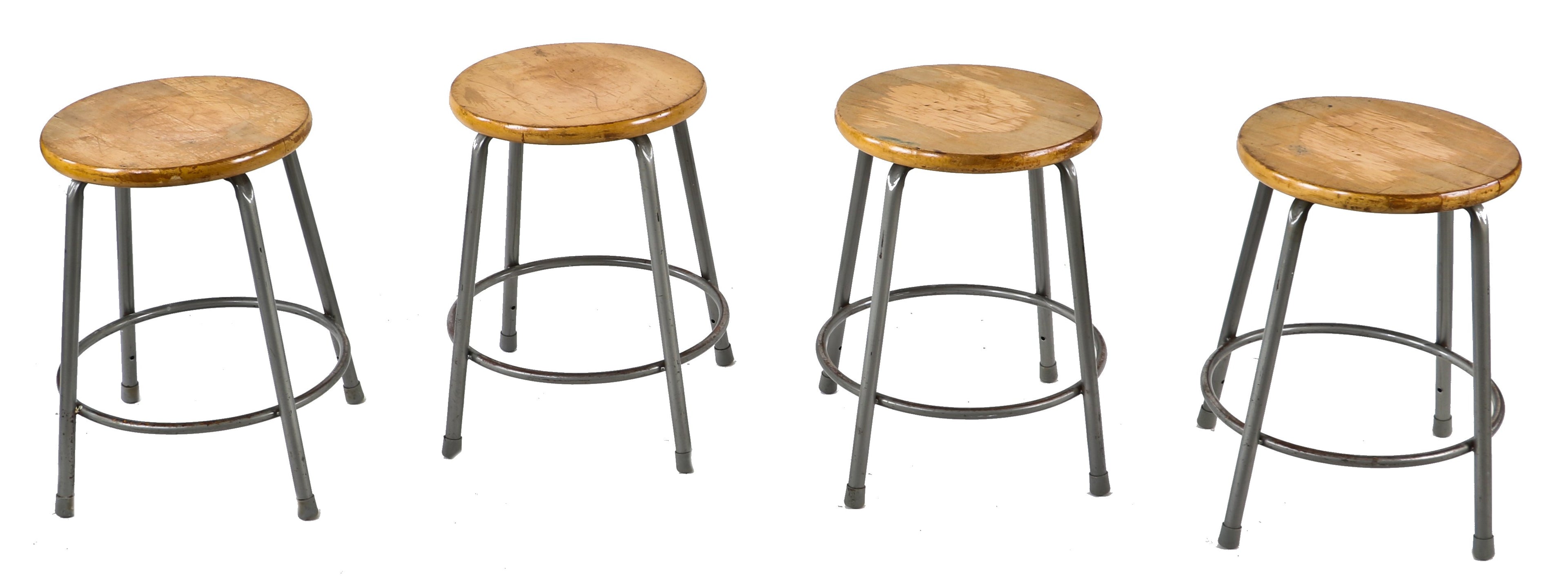group of four matching original and intact low-lying industrial tubular steel factory machine shop stationary stools with intact solid maple wood circular-shaped seats
