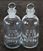 two matching vintage american industrial diminutive embossed cleat glass research laboratory reagent bottles with intact penny-shaped removable ground glass stoppers