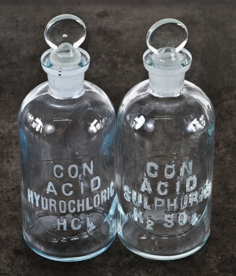 two matching vintage american industrial diminutive embossed cleat glass research laboratory reagent bottles with intact penny-shaped removable ground glass stoppers