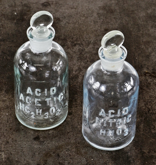 pair of original american industrial research science laboratory embossed clear glass reagent bottles with intact ground glass removable penny stoppers