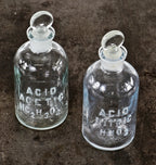 pair of original american industrial research science laboratory embossed clear glass reagent bottles with intact ground glass removable penny stoppers