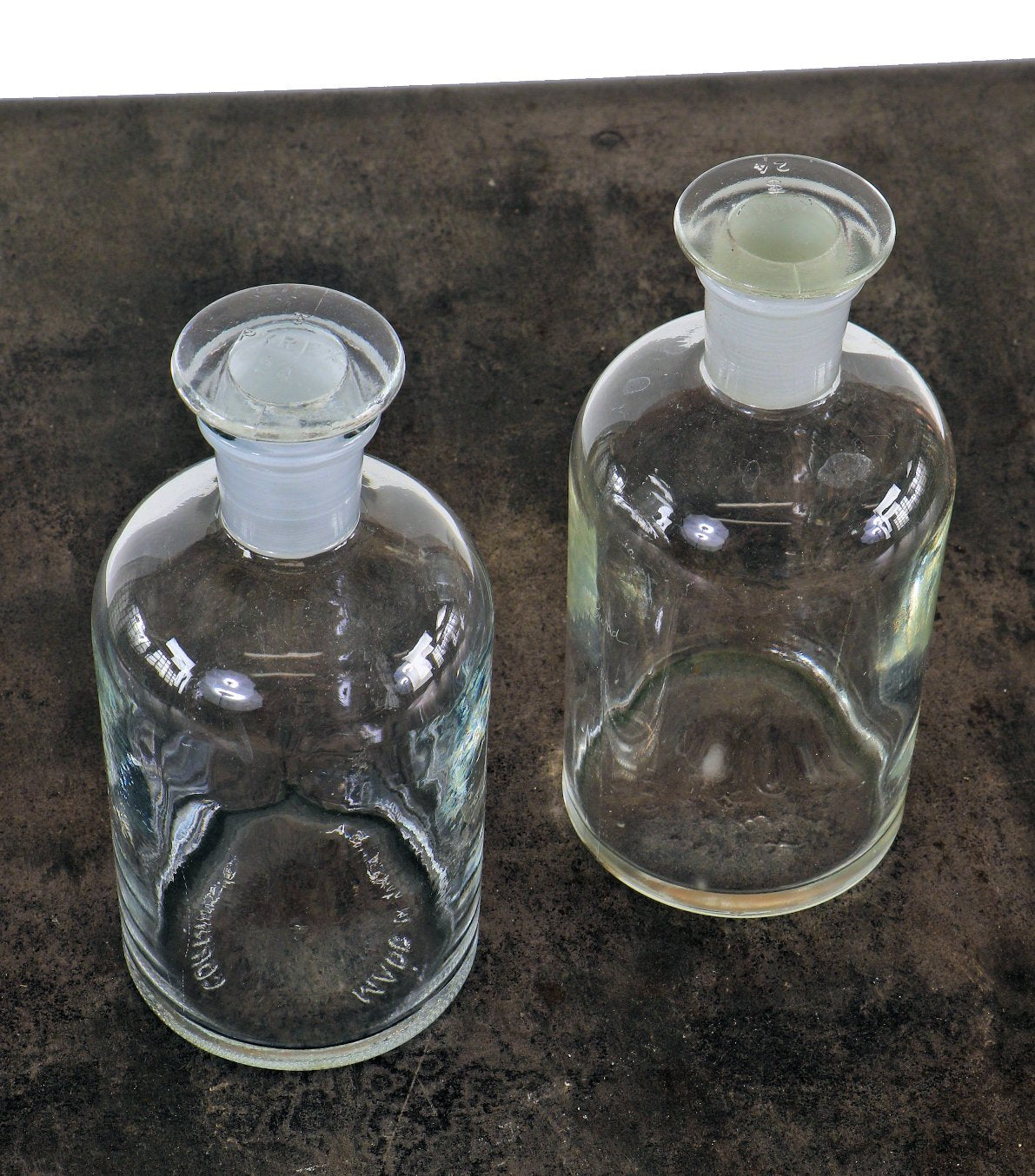 original american vintage industrial cylindrical-shaped clear glass chicago university research laboratory reagent bottles with sloping shoulders and ground glass stoppers