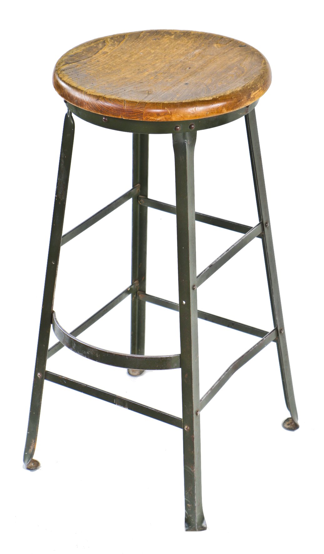 c. 1930's all original shopworn antique american industrial olive green enameled riveted joint angled steel factory stool with intact protruding footrest and solid maple wood seat