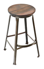 one of two matching original and intact american industrial late 1930's or 1940's refinished riveted joint stationary aeronautics factory stool with protruding footrest