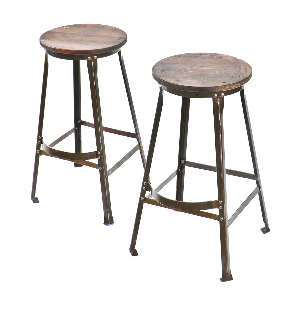 one of two matching original and intact american industrial late 1930's or 1940's refinished riveted joint stationary aeronautics factory stool with protruding footrest