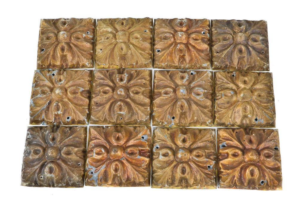 matching lot of twelve antique american schlitz saloon interior gold metallic enameled heavily ornamented tin ceiling panels with nicely aged surface patina