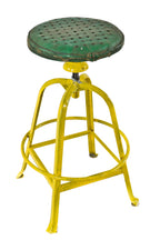 original c. 1930's antique american industrial four-legged yellow painted riveted joint adjustable height factory stool with intact highly desirable footrest and green cushioned seat