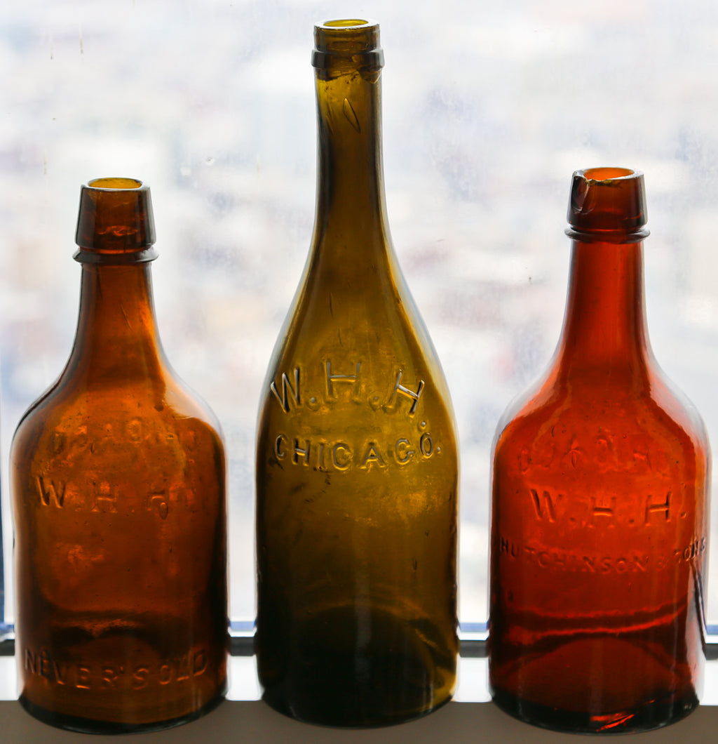 original and intact c. 1865-75 hard to find antique american amber glass squat quart ale bottle manufactured for william h. hutchinson bottling works.