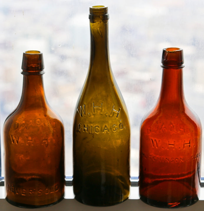 very rare and completely intact chicago privy dug c. 1865-7 deep olive green champagne shaped quart size bottle manufactured for chicago bottler william henry hutchinson.