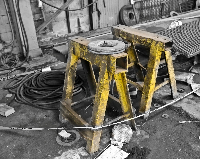set of nearly identical remarkably heavy yellow-painted depression era american industrial antique welded joint chicago foundry sawhorses