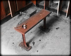 depression era antique american industrial salvaged stationary low-lying chicago foundry building locker room sitting bench with reinforced red painted cast iron legs