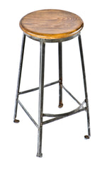 four-legged riveted joint stationary brushed pressed and folded antique american industrial factory machine shop stool with refinished maple wood seat