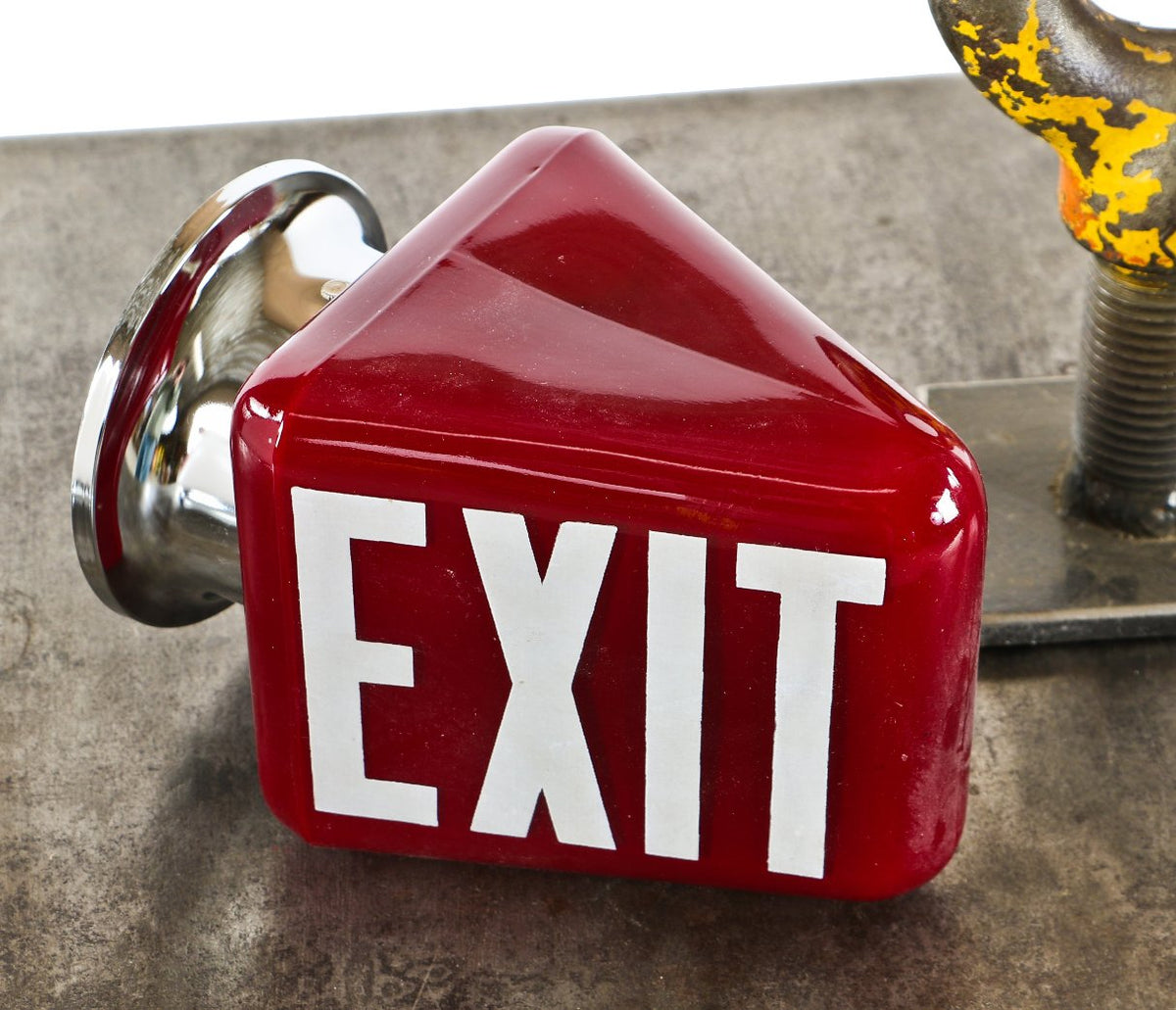 completely intact and fully functional ruby red glass wedge-shaped "exit" light wall sconce with intact spun steel fitter and bold double-sided white lettering