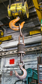 single oversized depression-era american industrial weathered and worn a. finkl & sons gantry crane solid steel lifting hook with robust suspension coil