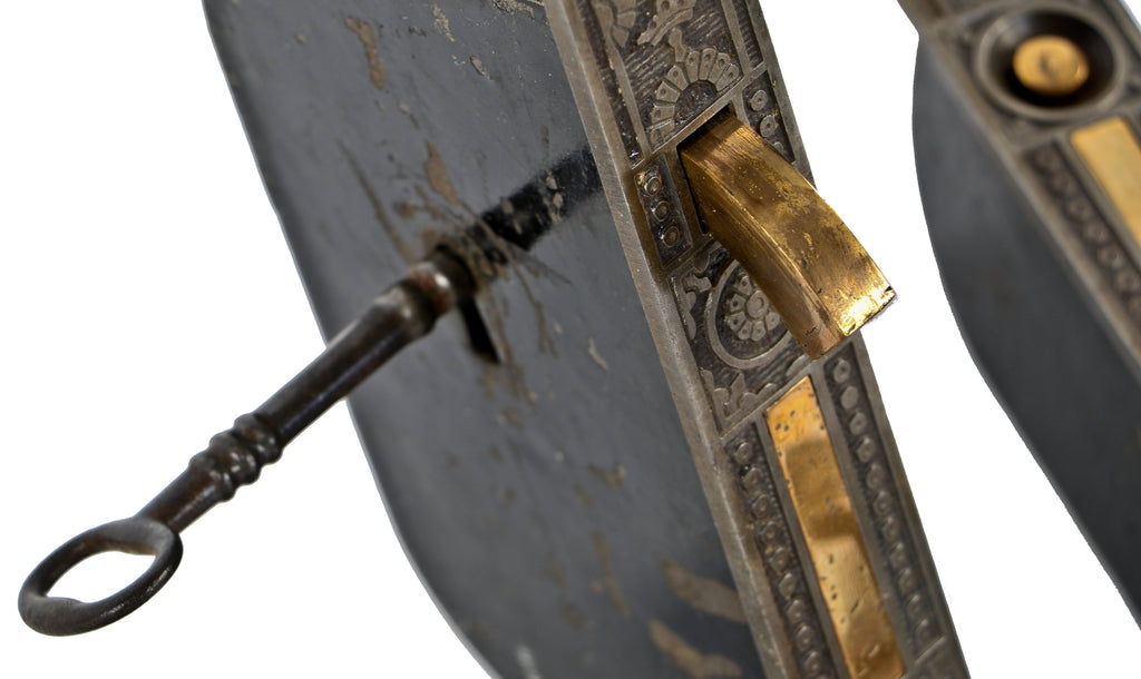hard to find completely intact "windsor" pattern 19th century eastlake style cast iron and brass residential pocket door set with functional skeleton key