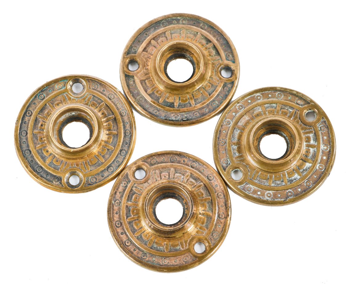 four matching 19th century original interior ornamental cast brass passage door circular-shaped rosettes with nicely aged surface patina throughout
