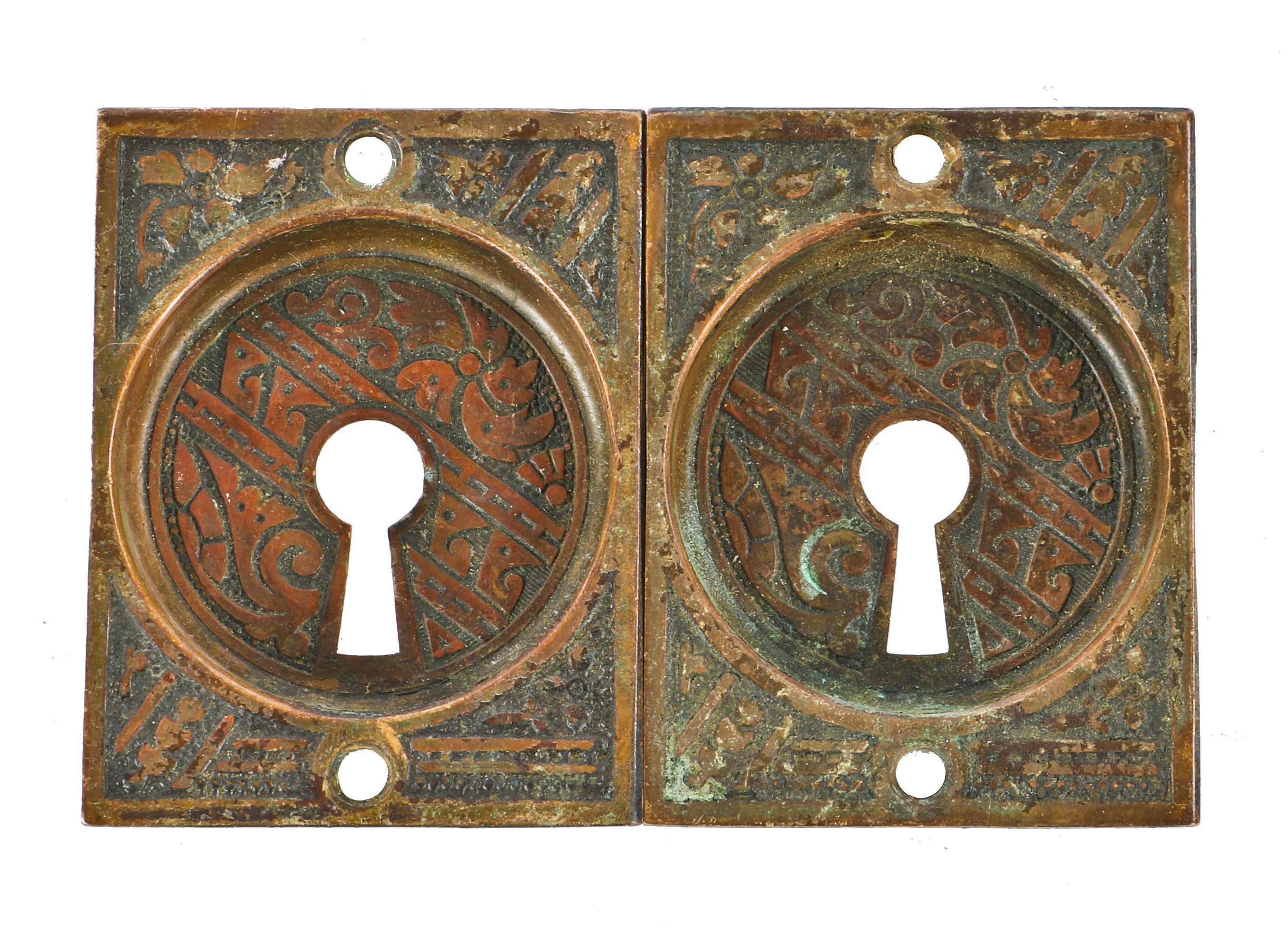 two matching original "ceylon" pattern stamped brass 19th century ornamental interior square-shaped pocket door escutcheons with keyhloles