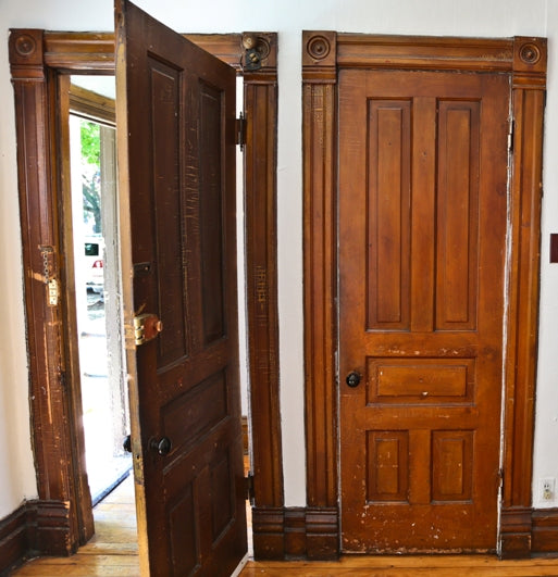 salvaged original c. 1880's interior residential raised panel pine wood varnished passage door with intact "jet black" porcelain doorknobs and ornamental cast iron rosettes