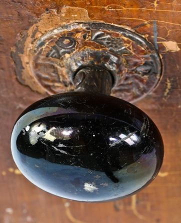 salvaged original c. 1880's interior residential raised panel pine wood varnished passage door with intact "jet black" porcelain doorknobs and ornamental cast iron rosettes