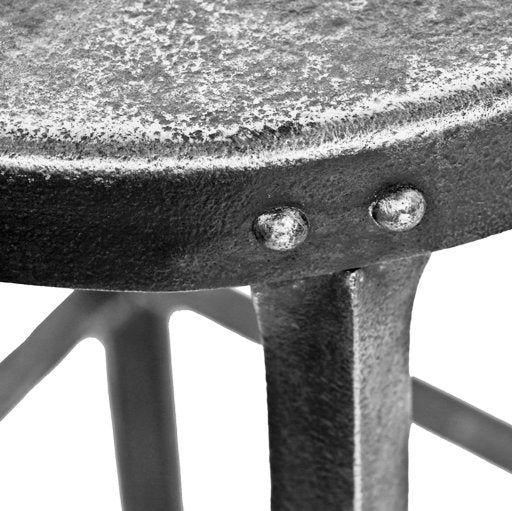 structurally sound and heavily reinforced late 1920's american antique industrial riveted-joint heavy gauge angled steel four-legged elevator machine room stool with brushed metal finish
