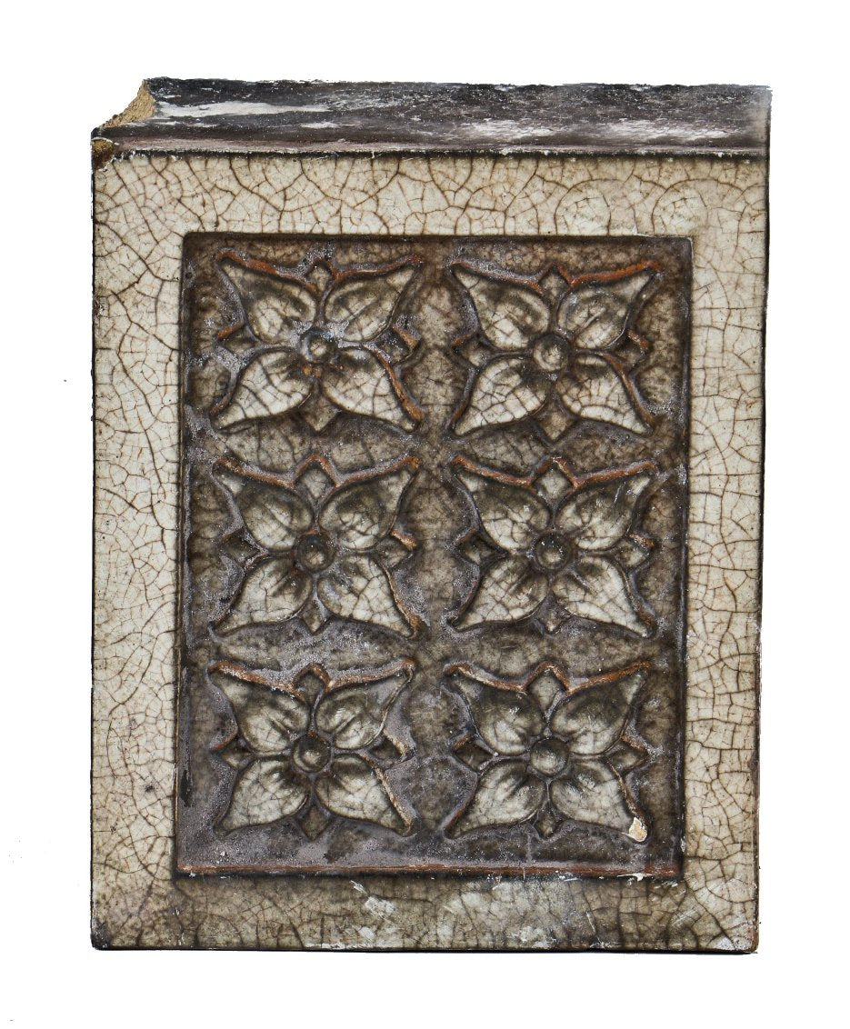 early 20th century single "stock" white glazed terra cotta chicago building facade ornamental block featuring intricate floral motifs surrounded by raised edges
