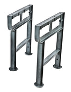 two matching solidly cast early 20th century antique american industrial cast iron factory machine shop workbench legs with uniform metallic gray finish