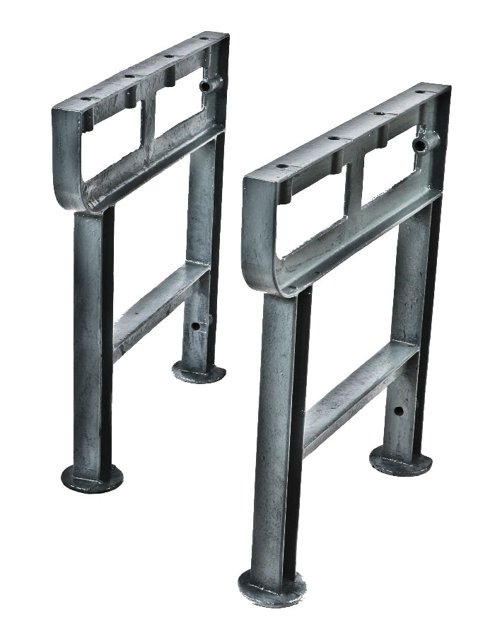 two matching solidly cast early 20th century antique american industrial cast iron factory machine shop workbench legs with uniform metallic gray finish