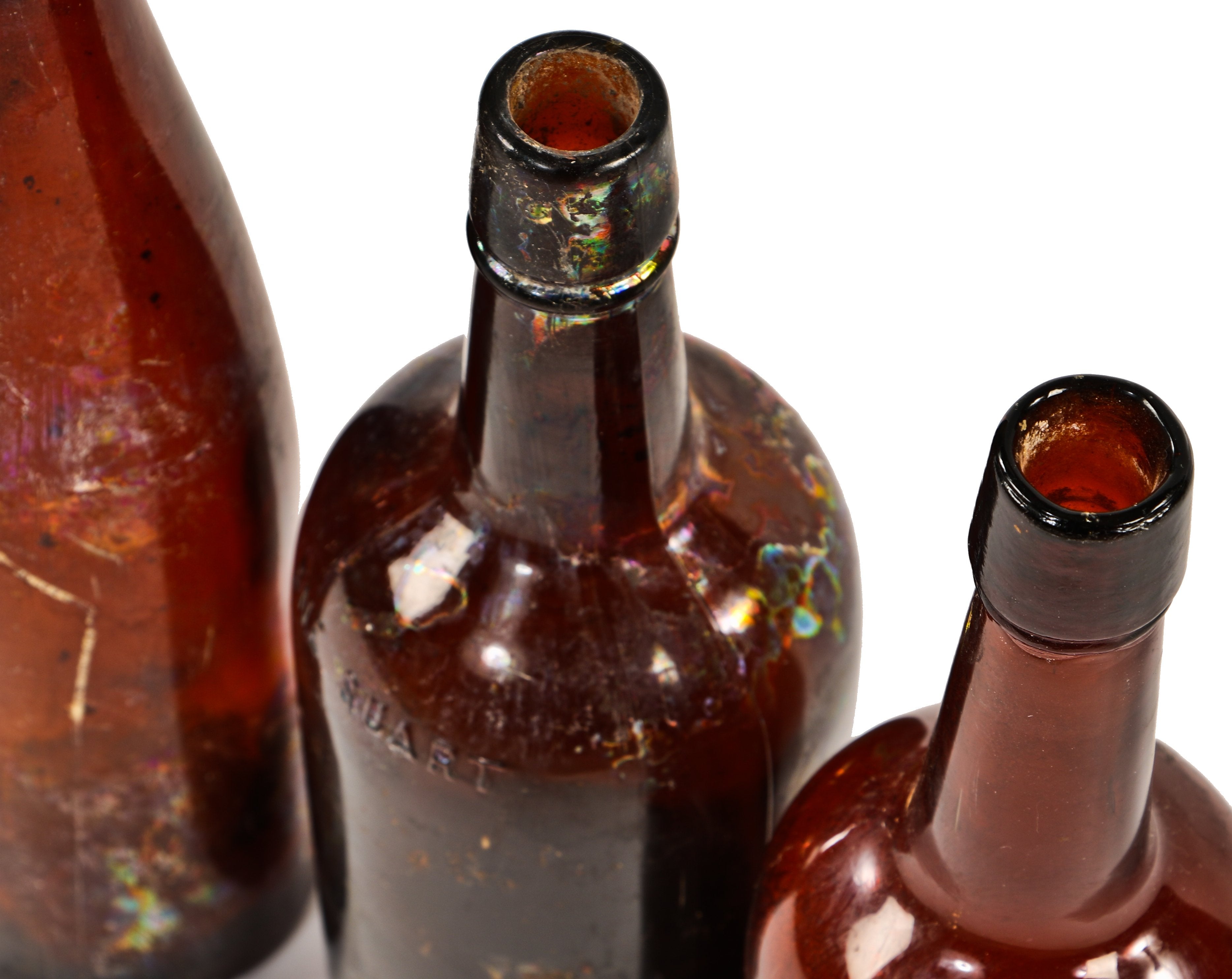assortment of three hand-blown dark amber colored glass 19th century antique american oversized privy dug whiskey and wine bottles with applied lips