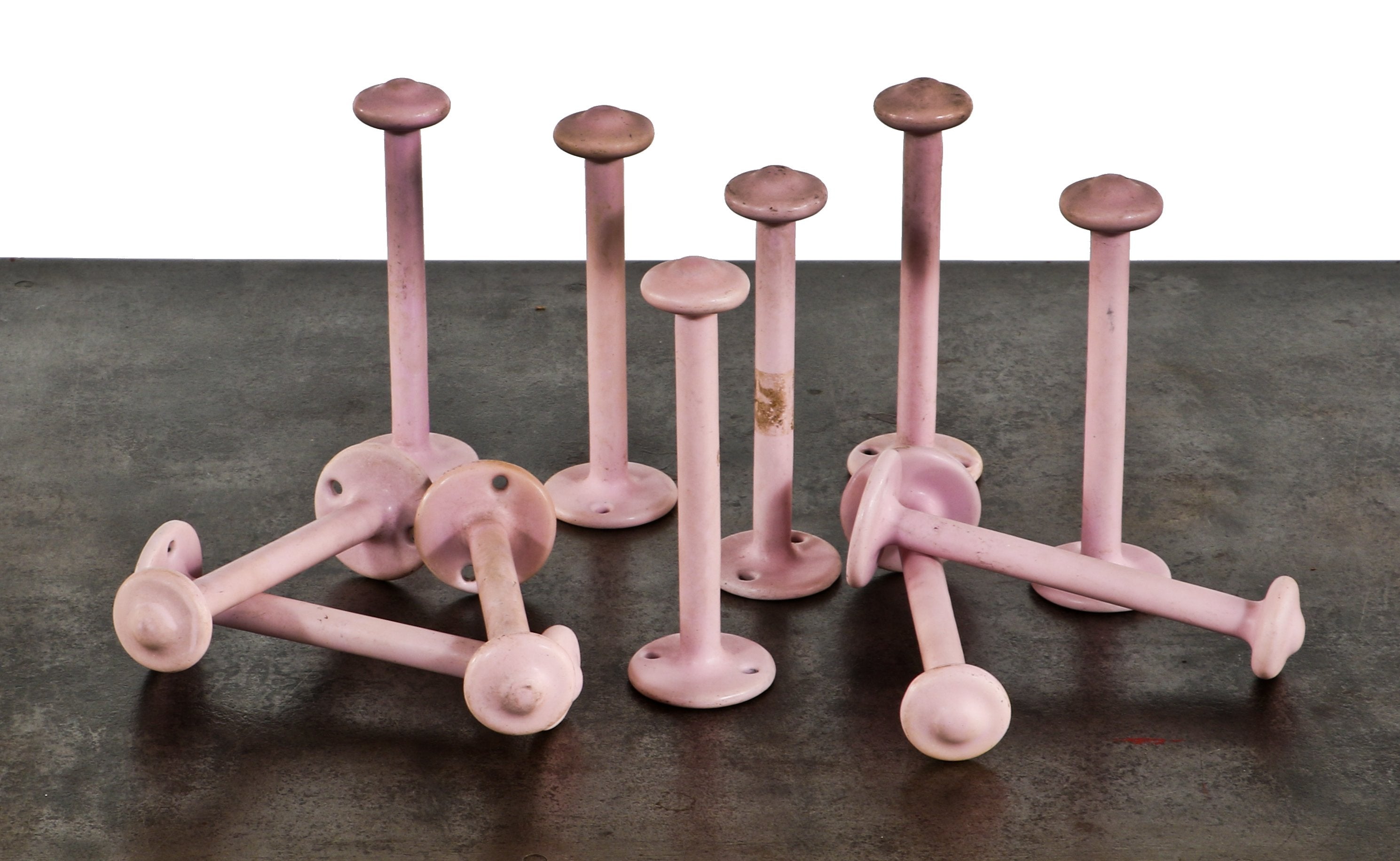large lot of matching oversized early 1930's chicago art deco hotel building cast iron wall-mount garment or hat hooks with original pastel pink porcelain enameled finish