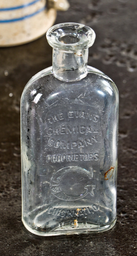 intact early 20th century original and intact chicago privy-dug "big g" gonorrhea elixir patent clear glass medicine bottle manufactured for the evans chemical company