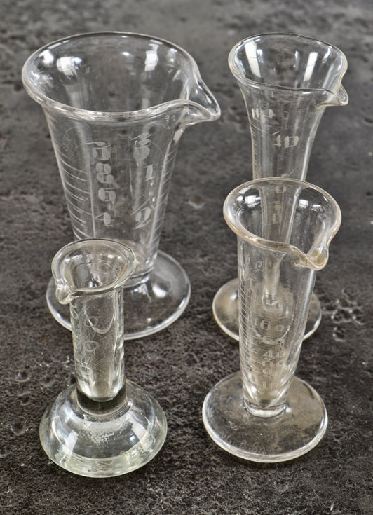group of antique american unique drugstore or apothecary diminutive etched glass freestanding conical-shaped measures with intact pedestal bases