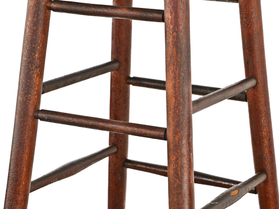 all original single turn of the century antique american solid birch wood tall four-legged darkly stained architect's drafting stool with slightly flared feet