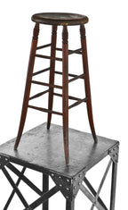 all original single turn of the century antique american solid birch wood tall four-legged darkly stained architect's drafting stool with slightly flared feet